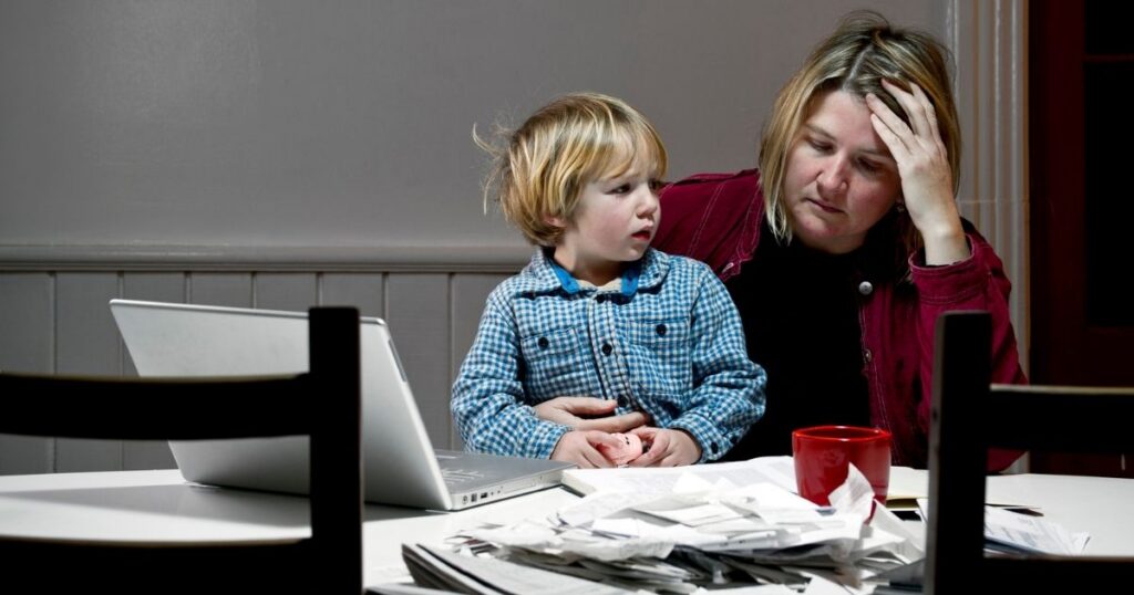 Stressed mother paying bills in Cherokee County